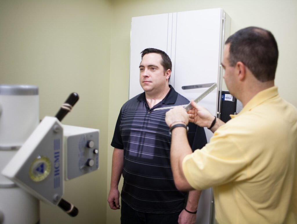 Dr. Sean Dunkle completing an x-ray on a patient at Care Chiropractic in Marion IA. We serve the Marion, Cedar Rapids, Hiawatha and surrounding areas.